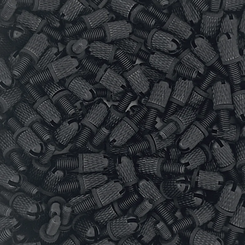 Close-up of many black thumbscrews